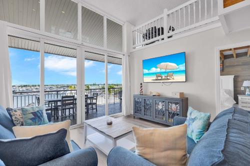 a living room with a view of the ocean at St Kitts - Downtown Waterfront Penthouse Pool Dock Parking in Key West