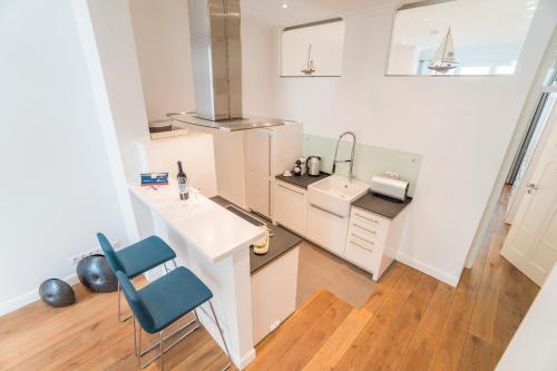 a kitchen with a counter and a sink and a desk at Appartement Baltic Pearl in Ostseebad Sellin