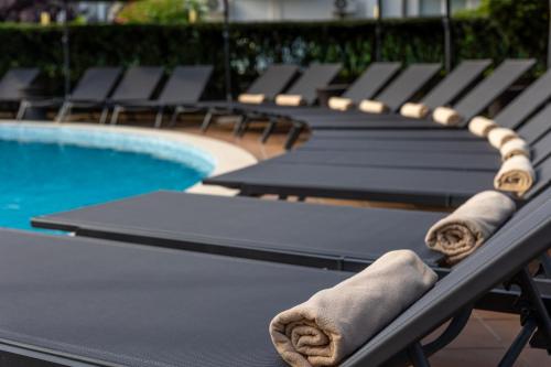 a ping pong table in front of a swimming pool at Selena Beach Family Hotel - All Inclusive Light in Sozopol
