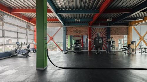 a large room with a gym with a hose at The Ruby Suite luxury room in Mexico City