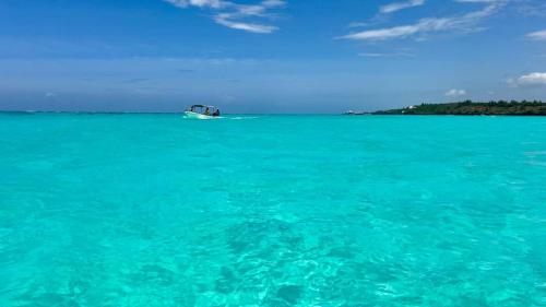 a boat in the middle of the ocean at Outdoor Cinema Group Friendly Retreat in Pingwe
