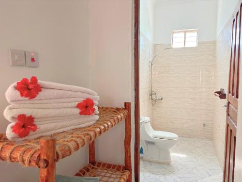 a bathroom with a towel rack and a toilet at Outdoor Cinema Group Friendly Retreat in Pingwe