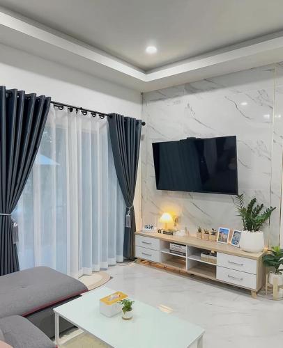 a living room with a flat screen tv on a wall at Peace Transit Hotel in Dar es Salaam