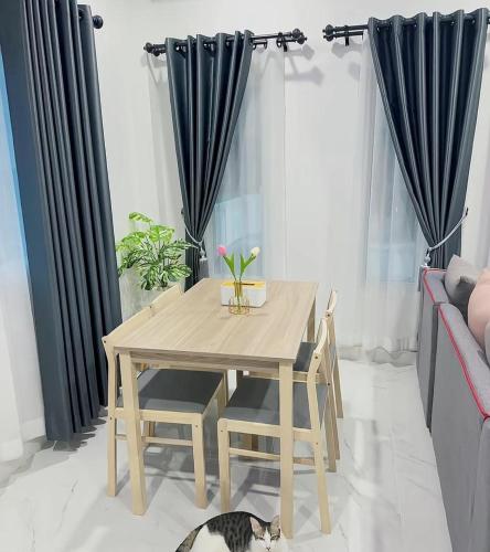 a wooden table and a cat laying on the floor in a living room at Peace Transit Hotel in Dar es Salaam