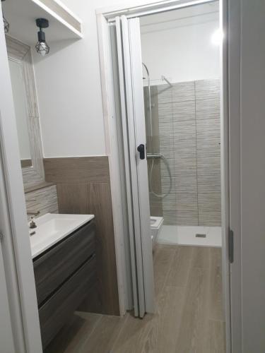 a bathroom with a white sink and a shower at Da zia Fabri in Gorizia