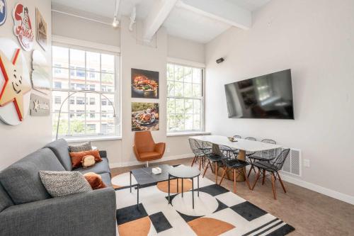 a living room with a couch and a table at The 333 Suites 203 - Stay for 6 in Cincinnati