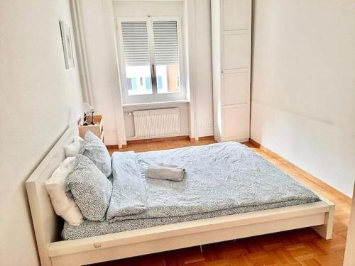 una camera da letto con un letto con una coperta blu e una finestra di Huge 3 Room City Center Flat, Zurich HB Konrad a Zurigo