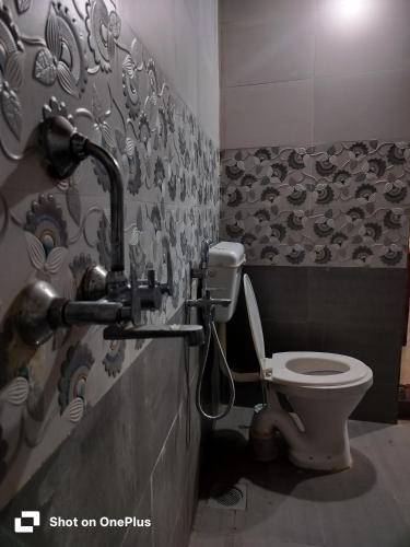 a bathroom with a toilet and a sink at Swastik Guest House in Arambol