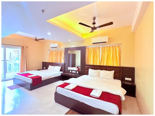 a bedroom with two beds and a ceiling at GC INTERNATIONAL - New Digha Sea Beach Hotel with SWIMMING POOL, PARKING, PRIVATE GYM, RESTAURANT in Digha