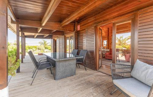 a patio with a table and chairs on a deck at Beautiful Home In Guardamar Del Segura in El Camino de Catral