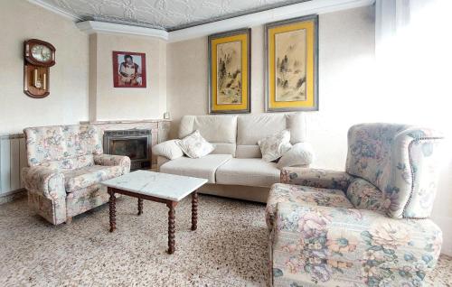 a living room with a couch and a chair at Casa Traiguera in Traiguera