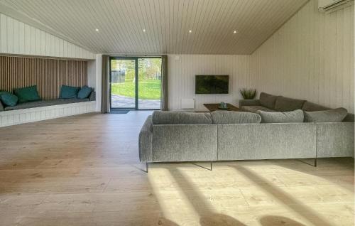 a living room with a couch and a table at Amazing Home In Sjællands Odde With Sauna in Yderby
