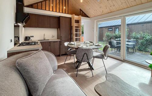 a kitchen and living room with a couch and a table at 3 Bedroom Pet Friendly Home In Oud Gastel in Zegge