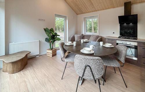 a kitchen and dining room with a table and chairs at 3 Bedroom Pet Friendly Home In Oud Gastel in Zegge
