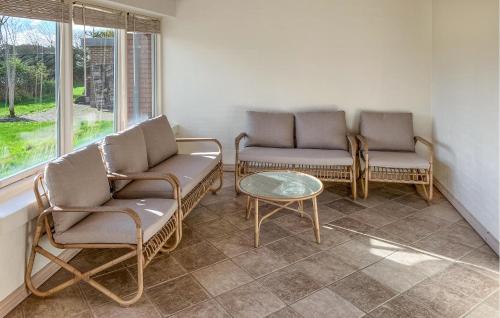 a living room with two chairs and a table at 5 Bedroom Awesome Home In Lemvig in Nørby