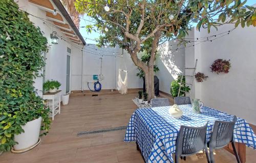 a room with a table and a tree in it at Stunning Home In Piles With Wifi in La Playa de la Torre de Piles