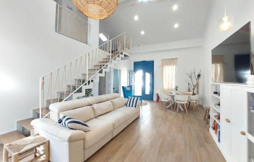 a living room with a couch and a staircase at Stunning Home In Piles With Wifi in La Playa de la Torre de Piles