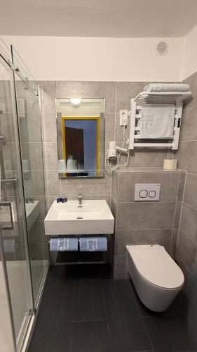 a bathroom with a sink and a toilet and a shower at Apartments Potz in Illmitz