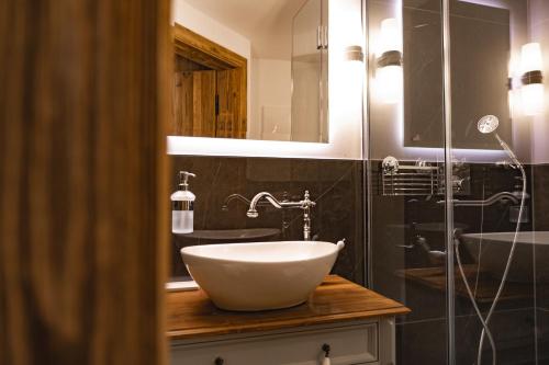 a bathroom with a white sink and a mirror at Löw Chalet Suite 3 in the heart of Kitzbühel by 360 Estates in Kitzbühel