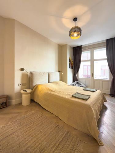 a bedroom with a large bed and a lamp at Continental Apartment in Unirii Square in Cluj-Napoca
