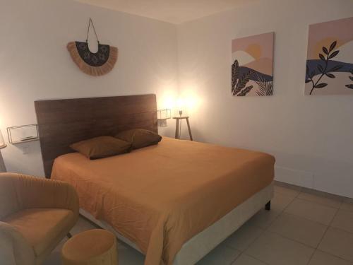 a bedroom with a bed and a chair at The One in Cul de Sac