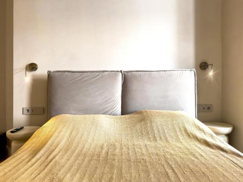 a bedroom with a bed with a blanket on it at Continental Apartment Unirii in Cluj-Napoca