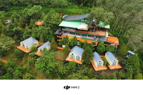an aerial view of a house in the forest at Two Tree Cafe At Suanmuangthong 