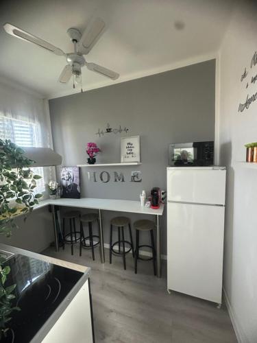 a kitchen with a counter and a white refrigerator at B&B Le Palme Fiera in Bologna