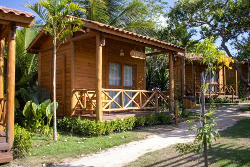 a cabin in the woods with a porch at Sitio Meu Refúgio Paracuru in Paracuru
