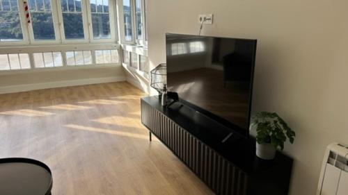 a living room with a large flat screen tv at LAIDA BEACH by Urdaibai Experience in Ibarrangelu