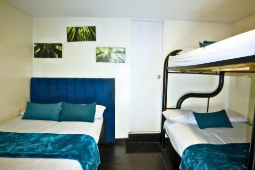 Ένα ή περισσότερα κρεβάτια σε δωμάτιο στο Hotel Bogota Home