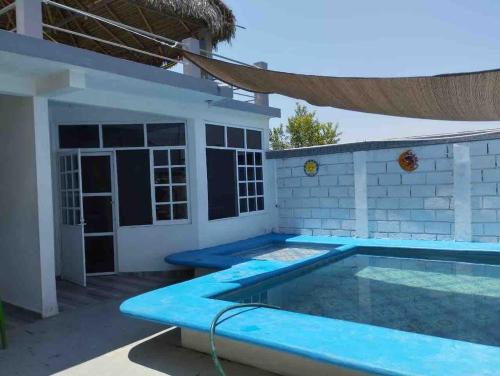 a swimming pool in front of a house at Casa Mia in Cedro