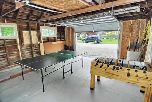 a ping pong table in a room with a ping pong table at Shores of Erie Guest House in Essex