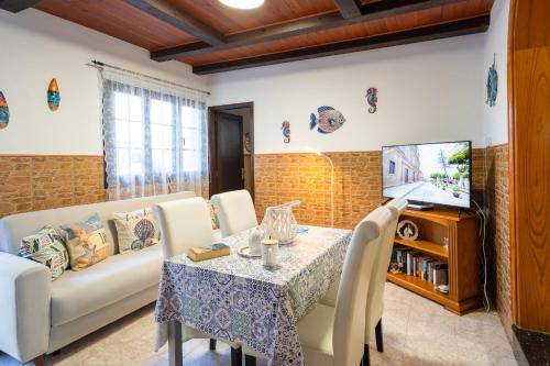 a living room with a table and a couch at Ocean views "Las Garzas" in Sardina