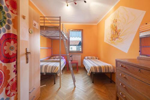 a bedroom with two bunk beds and a ladder at Da Roby - Villa Carolina in Fenis