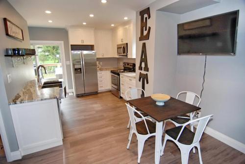 a kitchen and dining room with a table and chairs at Shores of Erie Guest House in Essex