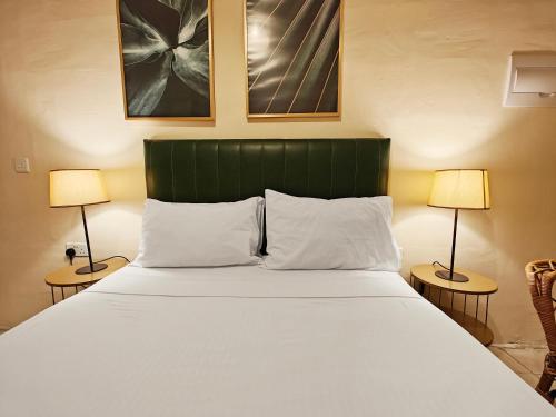 a bedroom with a large bed with two lamps at Bormla 1 in Cospicua