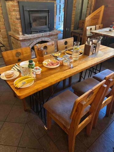 Una mesa de madera con platos de comida encima. en Penzion 4 pokoje, en Prostějov