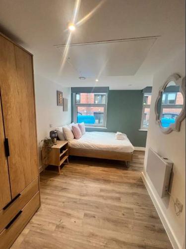 a bedroom with a bed and a large window at Studio Flat Close to Queen Square - Flat 4B in Bristol
