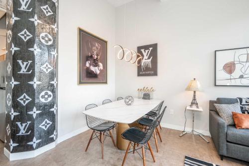 a living room with a table and chairs and a couch at The 333 Suites 301 - Suite for 6 in Cincinnati