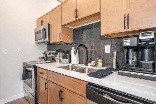 a kitchen with wooden cabinets and a sink at The 333 Suites 301 - Suite for 6 in Cincinnati