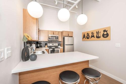 a kitchen with a counter and two stools at The 333 Suites 303 - Suite for 6 in Cincinnati