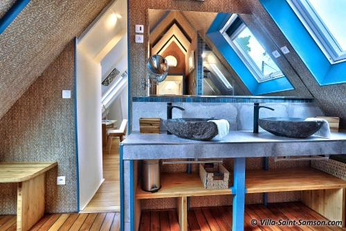 Un baño con dos lavabos y un espejo. en Villa Saint Samson, en Trégastel