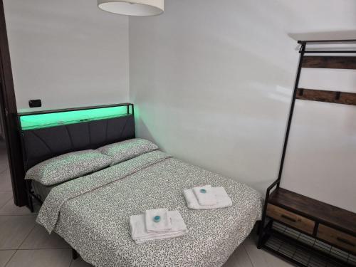 a bedroom with a bed with two towels on it at mirosa airport home in Macchie