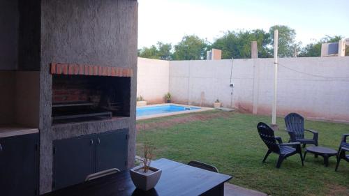 a patio with chairs and a table and a pool at Casa Oliva in Tinogasta