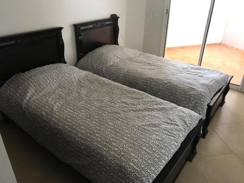 En eller flere senge i et værelse på Magnifique Appartement à Louer C14 Jnane Dalya