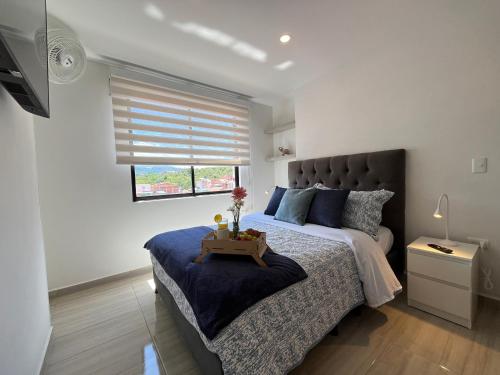 Postel nebo postele na pokoji v ubytování Moderno con ascensor y parqueadero a 5 min del CC