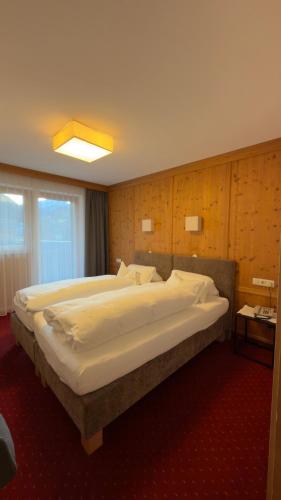 a bedroom with two large beds in a room at Hotel Sailer in Sankt Anton am Arlberg