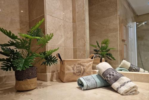 a bathroom with a shower with plants and towels at Marbella - Puerto Banus in Marbella