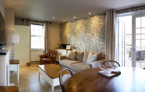 a living room with a couch and a table at Five Star Stays in Scarborough
